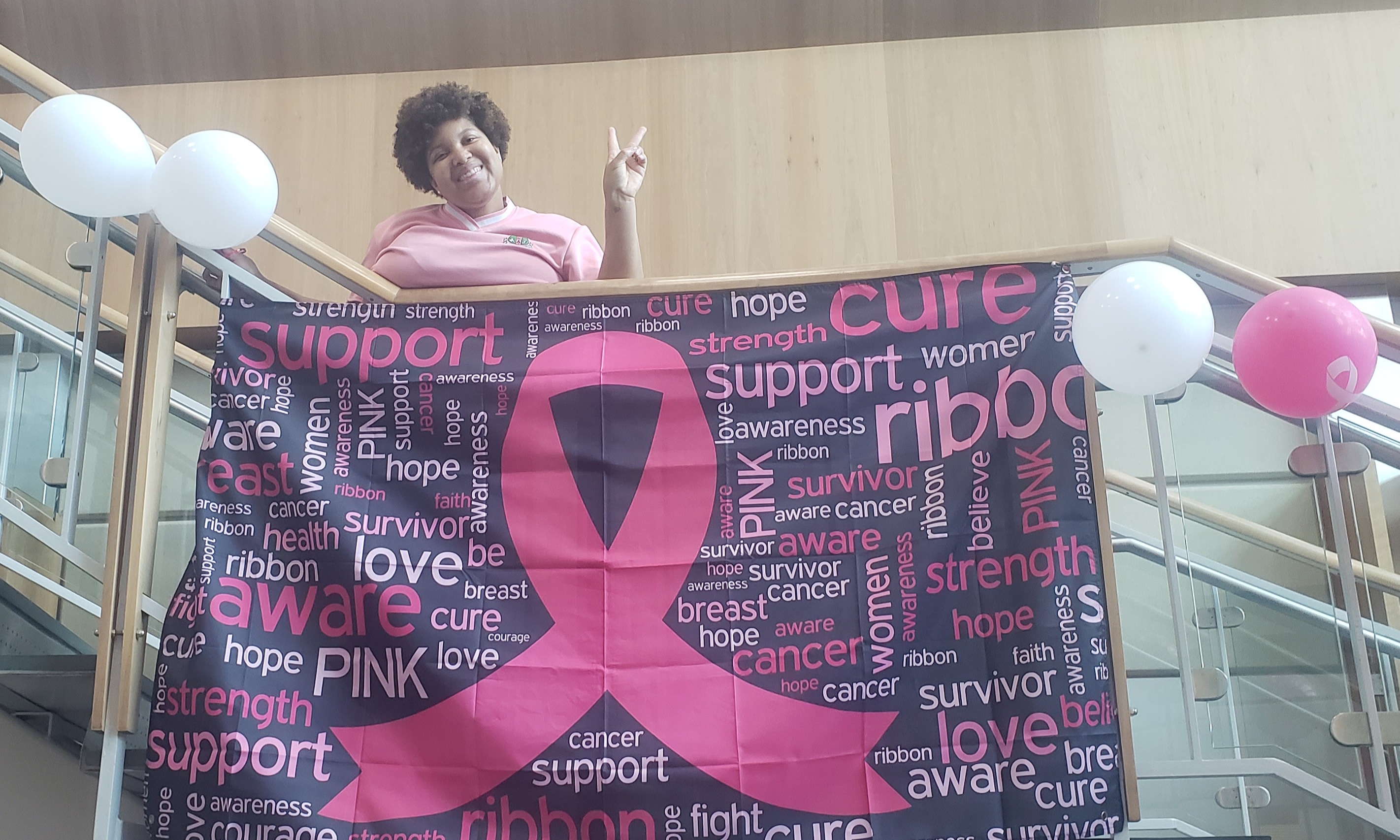 Prince Frederick Campus Student Life Assistant Courtney Hawkins decorates the campus for breast cancer awareness