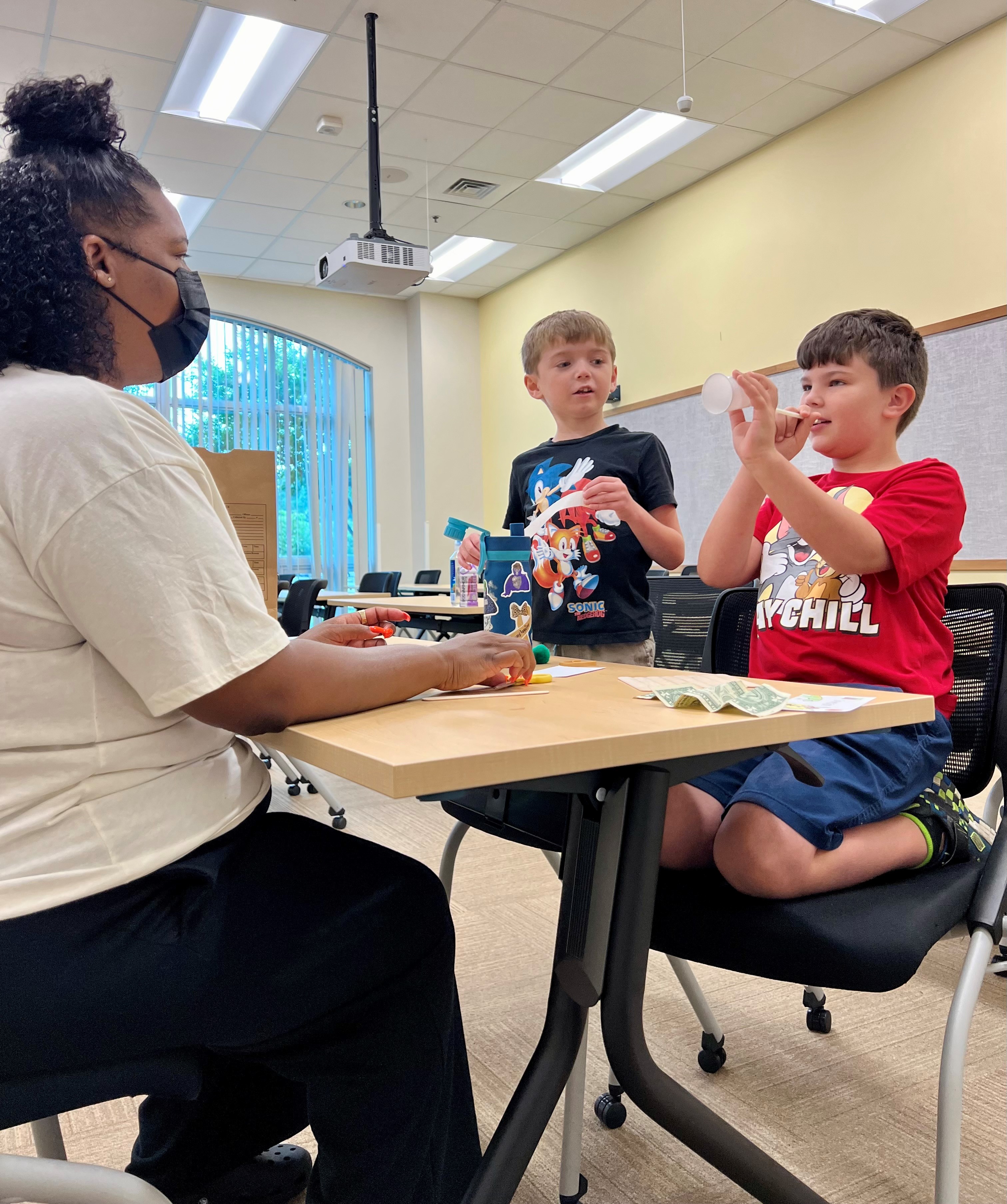 Instructor Janae Fenwick assists Eli Billard, left, and Jackson Thornton in a project at the summertime STEM class at the Prince Frederick Campus of College of Southern Maryland this week, as part of CSM’s summer Kids’ and Teen College for those ages 5-17