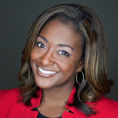 Headshot of CSM communication instructor Tamara Gibbs-Franklin wearing a red suit jacket and smiling at the camera.